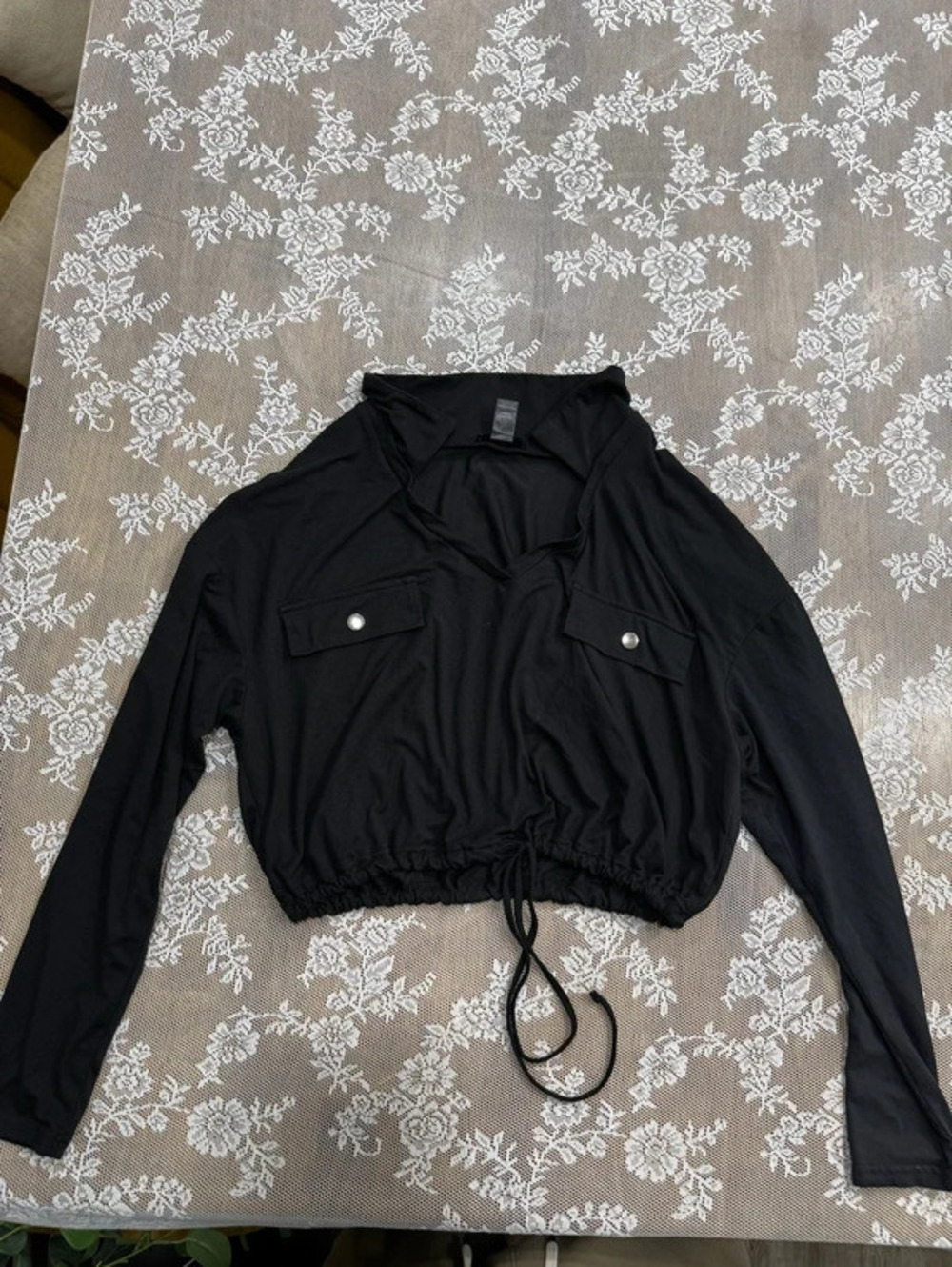 black blouse with front pockets and drawstring